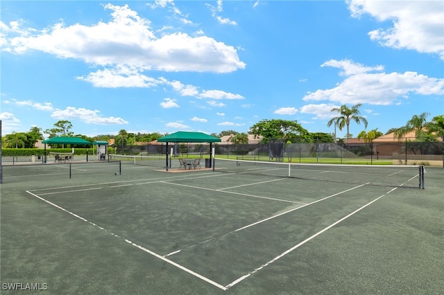 view of tennis court featuring fence