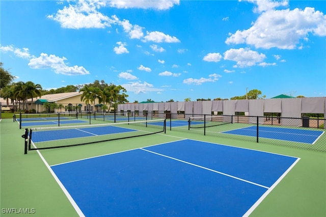 view of tennis court featuring community basketball court and fence