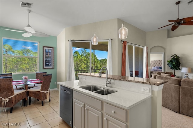 kitchen featuring pendant lighting, dishwasher, sink, ceiling fan, and a center island with sink