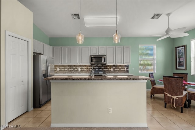 kitchen with appliances with stainless steel finishes, visible vents, and light tile patterned floors