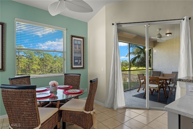 dining area featuring light tile patterned floors, plenty of natural light, baseboards, and ceiling fan