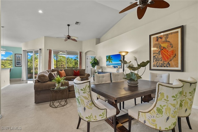 dining area featuring arched walkways, ceiling fan, visible vents, and light colored carpet