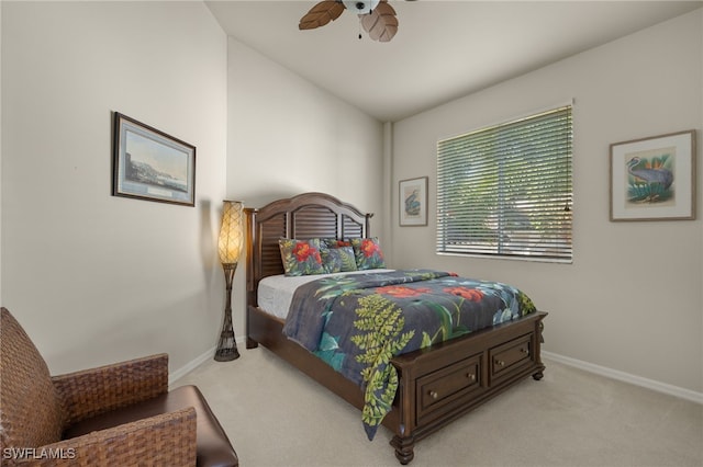 carpeted bedroom with lofted ceiling, a ceiling fan, and baseboards