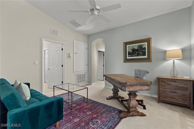 interior space featuring light colored carpet, arched walkways, visible vents, and baseboards