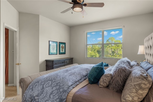 bedroom featuring light carpet and ceiling fan