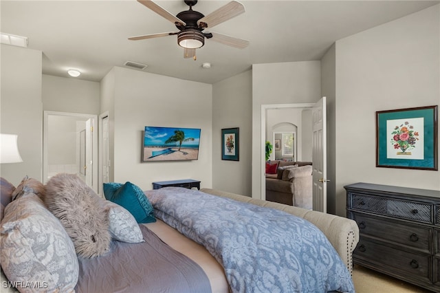 bedroom with light carpet, visible vents, and a ceiling fan