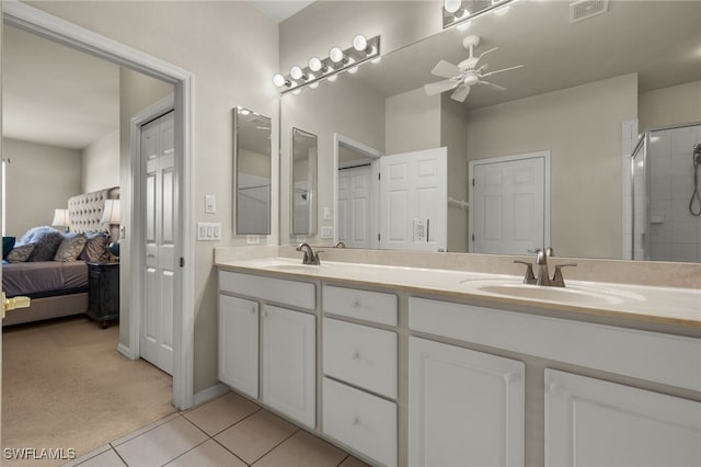 ensuite bathroom with double vanity, visible vents, a ceiling fan, a sink, and tile patterned flooring