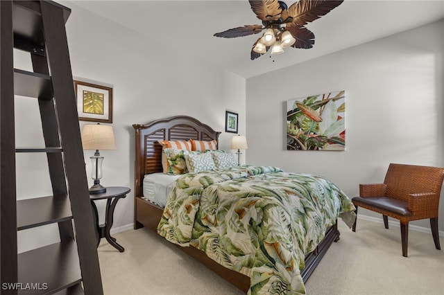 carpeted bedroom featuring ceiling fan and baseboards