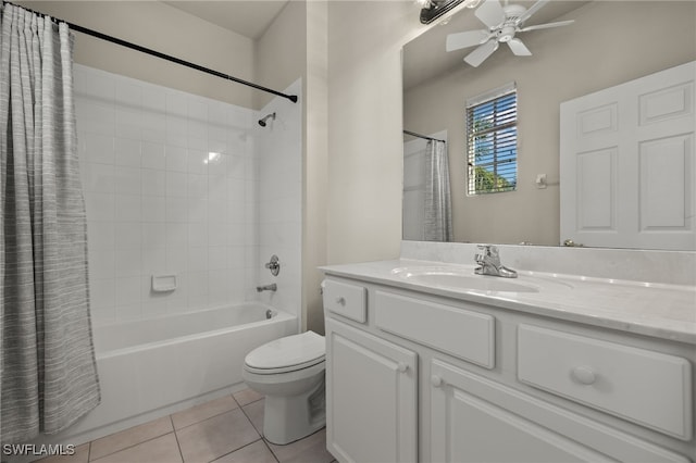 bathroom featuring toilet, ceiling fan, tile patterned flooring, shower / bath combo with shower curtain, and vanity