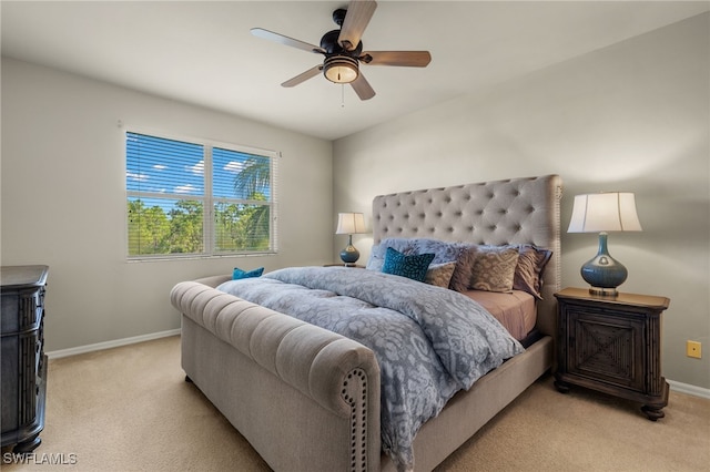 bedroom with light carpet, ceiling fan, and baseboards