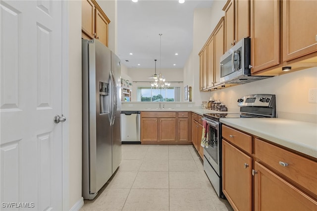 kitchen featuring pendant lighting, light tile patterned flooring, sink, a chandelier, and appliances with stainless steel finishes