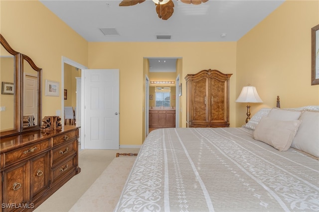 carpeted bedroom featuring ensuite bath and ceiling fan