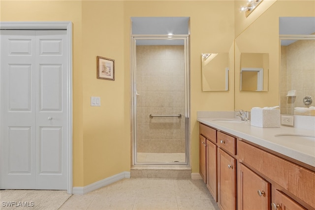 bathroom featuring walk in shower, vanity, and tile patterned floors