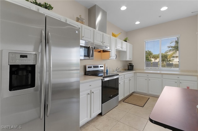 kitchen with white cabinets, sink, stainless steel appliances, and light tile patterned floors