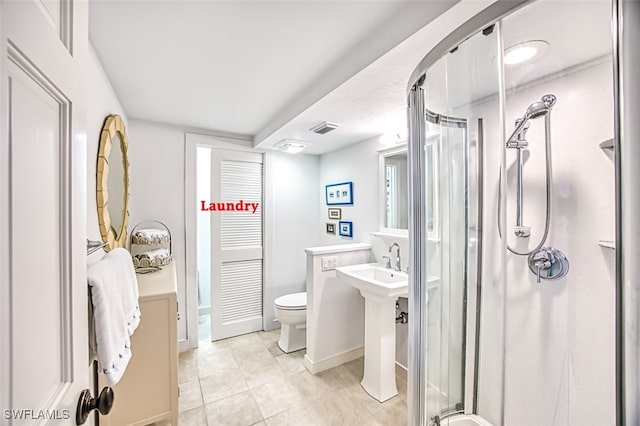 bathroom with tile patterned flooring, toilet, visible vents, baseboards, and a stall shower