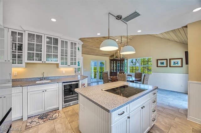 kitchen with visible vents, wine cooler, black electric cooktop, french doors, and a sink