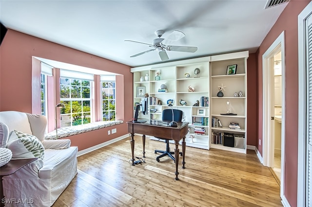 office with ceiling fan, baseboards, visible vents, and light wood-style floors