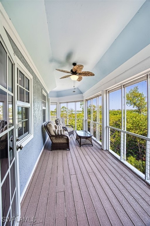 unfurnished sunroom featuring lofted ceiling and a ceiling fan