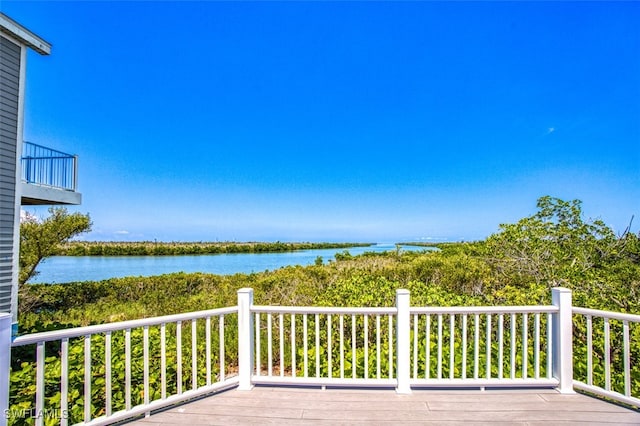 wooden deck featuring a water view