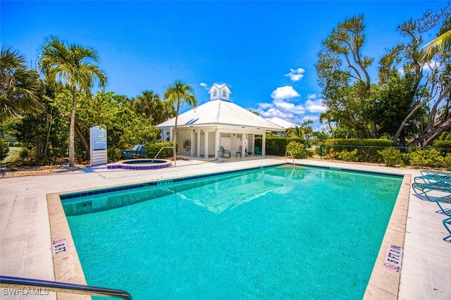 pool featuring a gazebo, a patio, and a hot tub