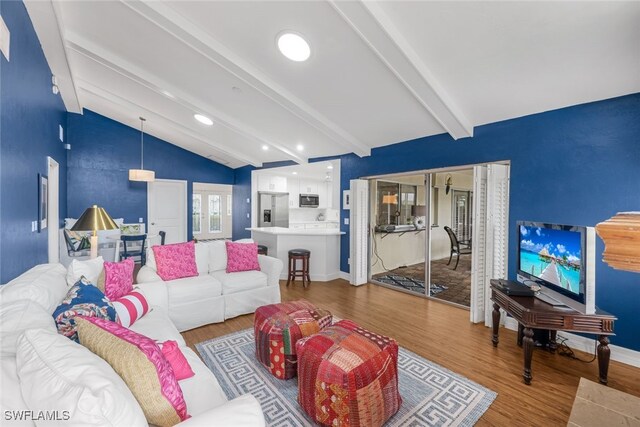 living room featuring hardwood / wood-style floors and lofted ceiling with beams