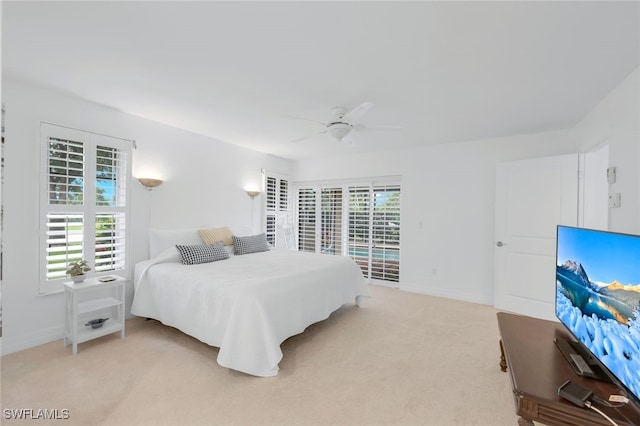 bedroom with ceiling fan and light carpet