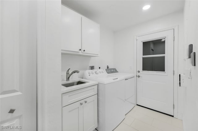 laundry room featuring cabinets, sink, light tile patterned floors, and washer and clothes dryer