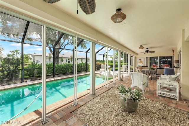 view of pool featuring a lanai, a patio area, and ceiling fan