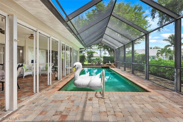 view of pool with a patio and a lanai