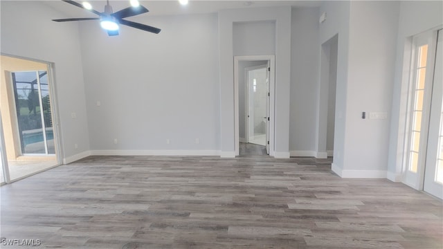 unfurnished room featuring light wood-type flooring, plenty of natural light, and ceiling fan