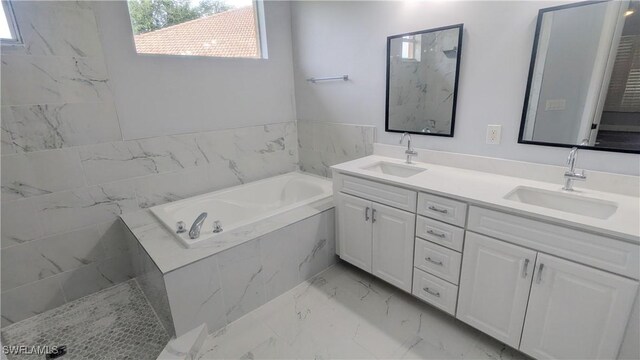 6733 Bent Grass Dr, Naples, FL 34113 - bathroom featuring marble finish floor, double vanity, a bath, and a sink