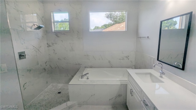 bathroom featuring vanity, plenty of natural light, and separate shower and tub