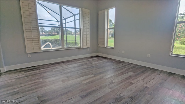 unfurnished room with plenty of natural light and hardwood / wood-style floors