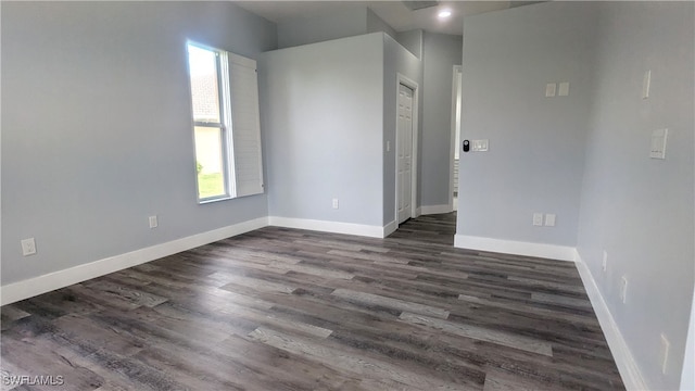 empty room with dark wood-type flooring