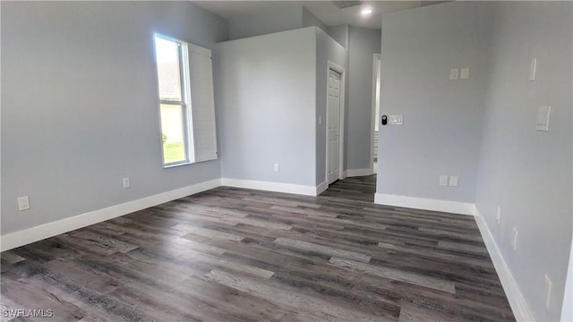 6733 Bent Grass Dr, Naples, FL 34113 - spare room with baseboards and dark wood-style floors