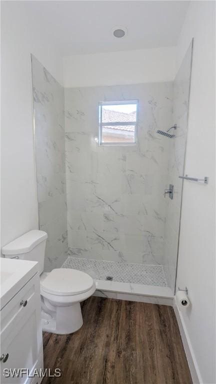 6733 Bent Grass Dr, Naples, FL 34113 - bathroom featuring wood finished floors, toilet, vanity, and a stall shower