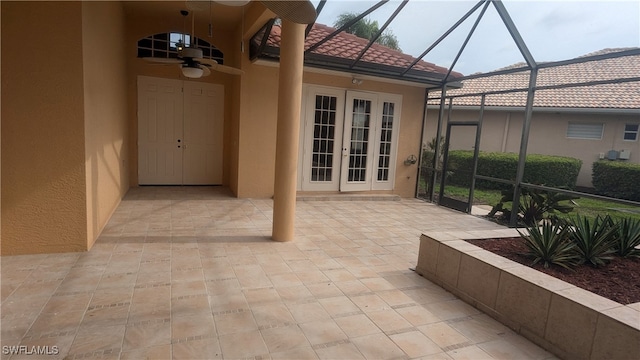 view of patio / terrace with ceiling fan, glass enclosure, and french doors