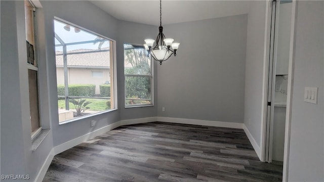 6733 Bent Grass Dr, Naples, FL 34113 - unfurnished dining area featuring baseboards, dark wood-style flooring, and a chandelier