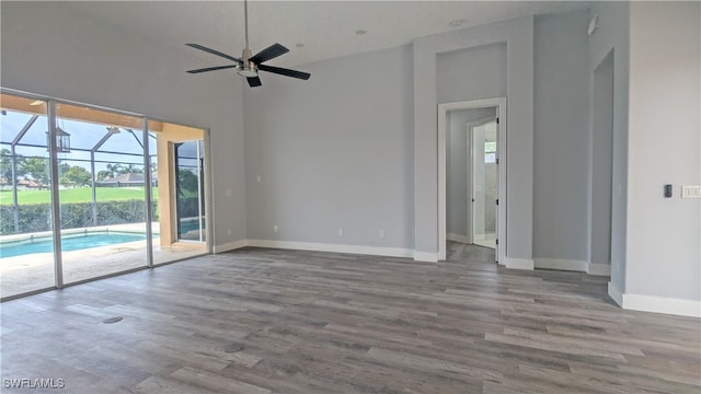 unfurnished room featuring high vaulted ceiling, ceiling fan, and hardwood / wood-style flooring