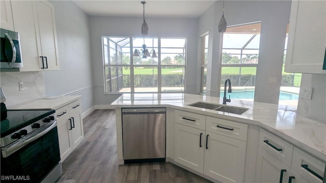 6733 Bent Grass Dr, Naples, FL 34113 - kitchen with white cabinetry, a sink, and appliances with stainless steel finishes