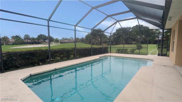 view of swimming pool featuring a lawn and a lanai