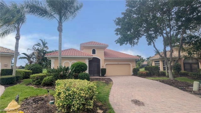 6733 Bent Grass Dr, Naples, FL 34113 - mediterranean / spanish-style house featuring a tile roof, driveway, stucco siding, and an attached garage