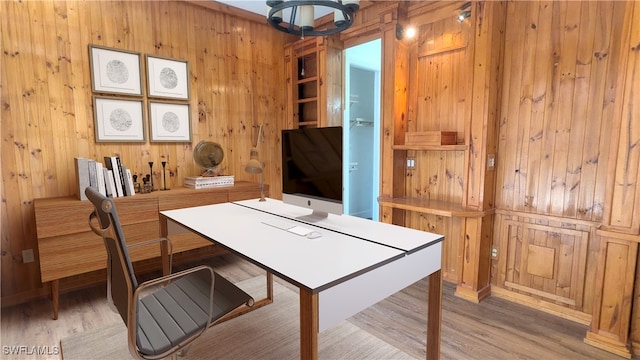 home office featuring wooden walls and light hardwood / wood-style floors