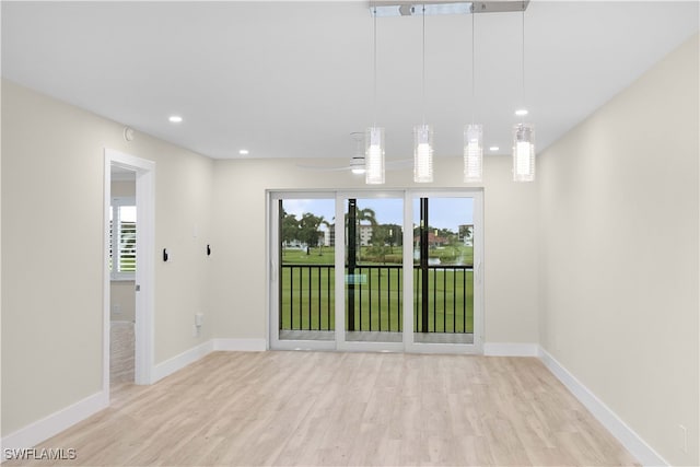 spare room featuring light wood-type flooring and ceiling fan