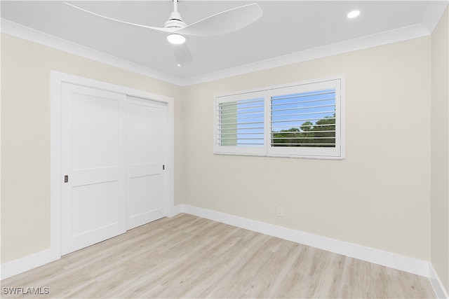 unfurnished bedroom with baseboards, crown molding, and wood finished floors