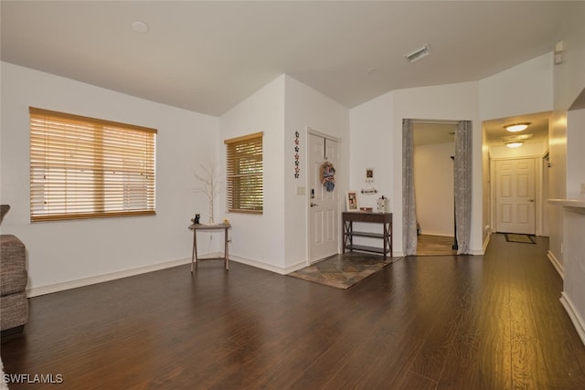 interior space with lofted ceiling and dark hardwood / wood-style floors