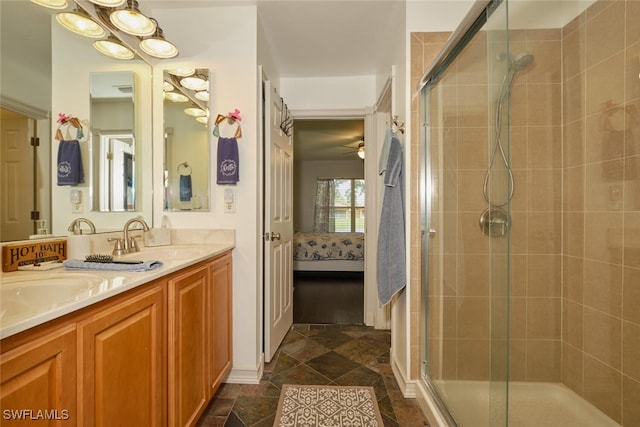 bathroom featuring vanity, a shower with shower door, and ceiling fan