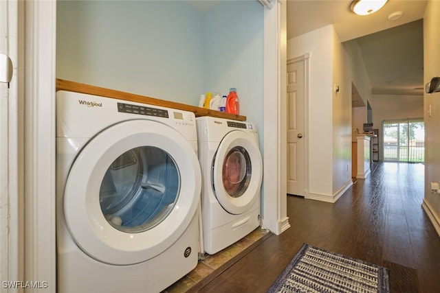 laundry area with dark hardwood / wood-style flooring and washer and clothes dryer