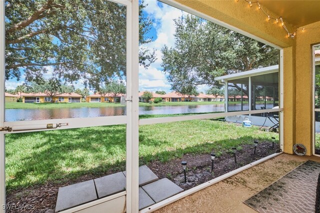 unfurnished sunroom featuring a water view