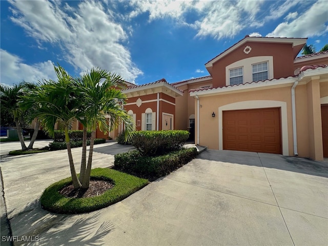 mediterranean / spanish-style house with a garage